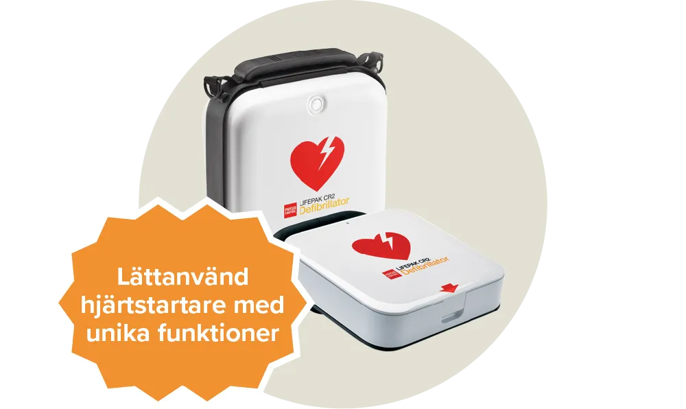 Vit hjärtstartare som har en röd hjärtikon med blix i mitten samt texten Lifepak cr2 defibrillator . Etikett: Lättanvänd hjärtstartare med unika funktioner