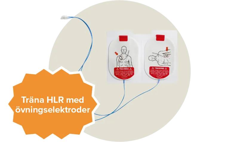 En vit och röd övningselektrod som passar till hjärtstartaren Philips heartstart frx. Etikett: Träna HLR med övrningselektroder.