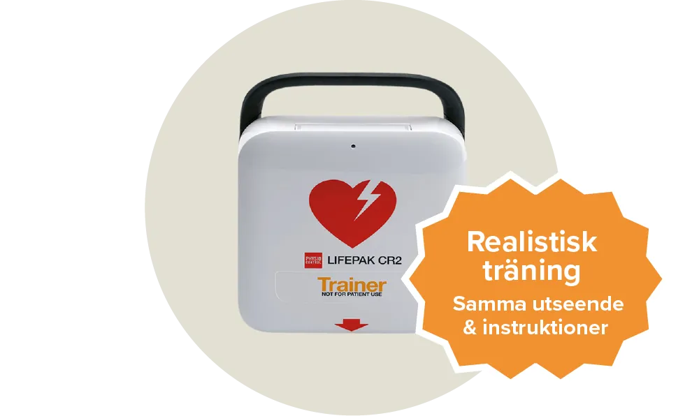 En vit övningshjärtstartare med ett rött hjärta på från märket Lifepak cr2. Etikett: Realistisk träning, samma utseende & instruktioner.