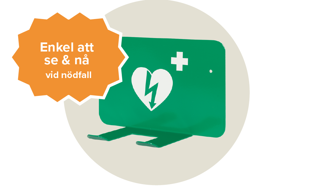 Ett grönt väggfäste för hjärtstartare med ett vit hjärta på. Passa till bl.a. cardiac science powerheart aed g5. Etikett: Enkel att se & nå vid nödfall.